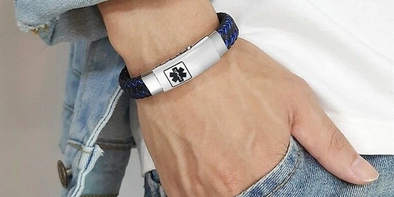 Medical ID Bracelet on a mans wrist with a black Staff of Asclepius symbol.