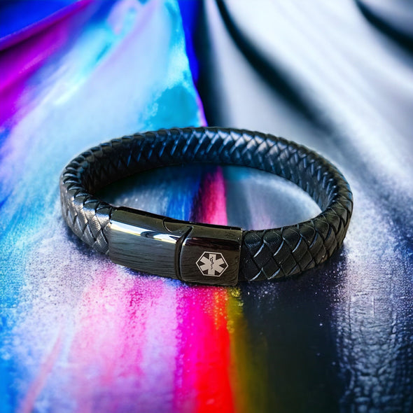 Customisable black microfibre leather and stainless steel medical alert bracelet on multicolour backdrop