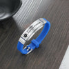 Barcelona personalised blue silicone medical alert bracelet on grey wooden table