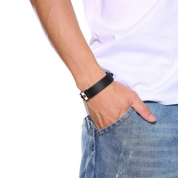 Man in white shirt and denim jeans wearing the Bermuda Black Silicone and Stainless Steel Customisable Medical Alert Bracelet