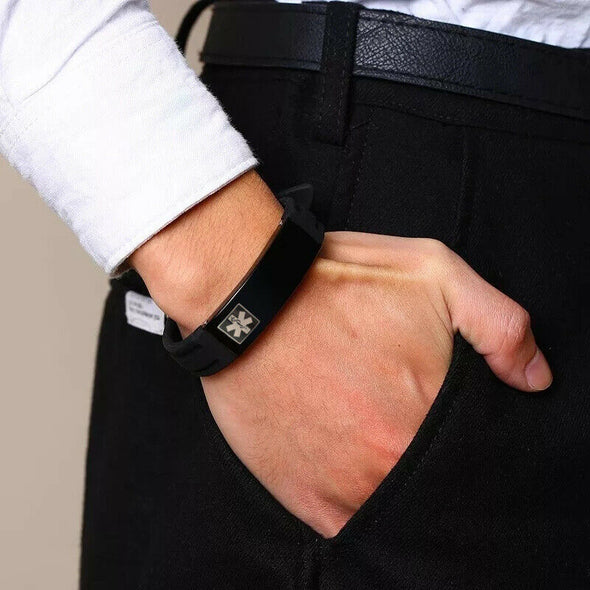 Boston black silicone and stainless steel tag medical alert bracelet worn by a business executive.