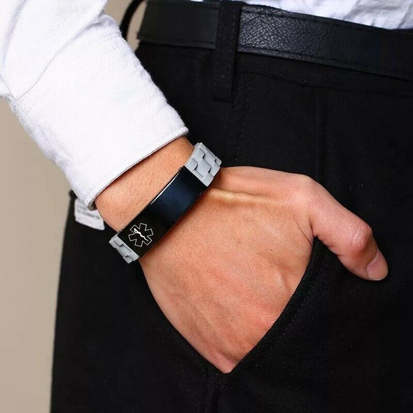 Brooklyn medical alert ID bracelet in grey with black tag, shown on the wrist of a business executive.