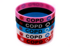 COPD medical alert silicone wristbands in a stack showing pink, black, blue, white and red colour-ways.