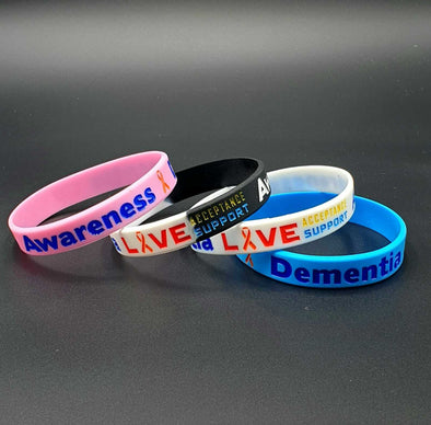 Dementia multi-coloured awareness silicone wristbands in pink, black/white,white and blue.