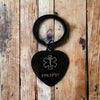 Customisable Black Epilepsy heart stainless steel keyring on a wooden table