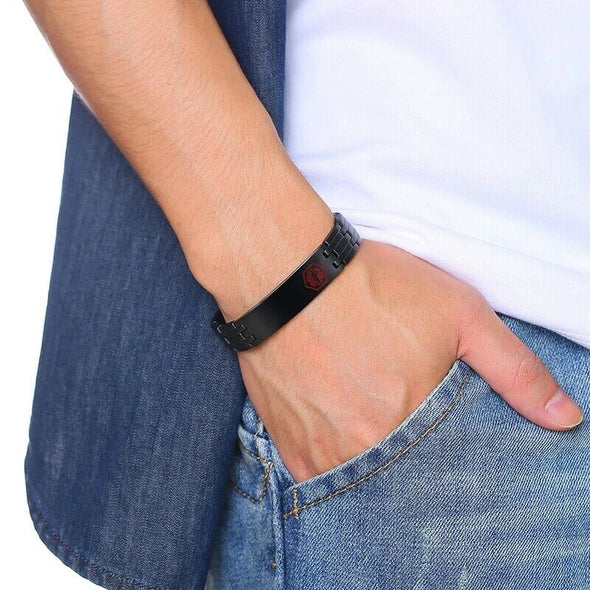 Customisable Graphite black stainless steel medical alert bracelet worn on a male model in denim shirt, jeans and white top.