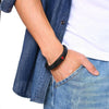 Lawnton black leather medical alert bracelet worn by a male model wearing denim and a white shirt