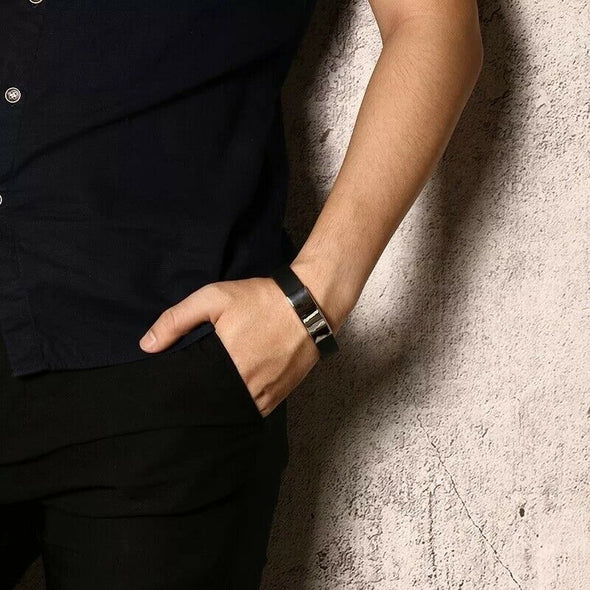 Nero black silicone and stainless steel customisable medical alert bracelet worn on a male model wearing all black.