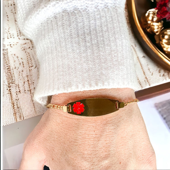 The Paris gold customisable stainless steel medical alert bracelet being worn on a woman's wrist.