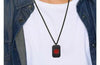 Squadron dog tag style medical alert necklace in black worn on a male model with a white top and denim shirt.