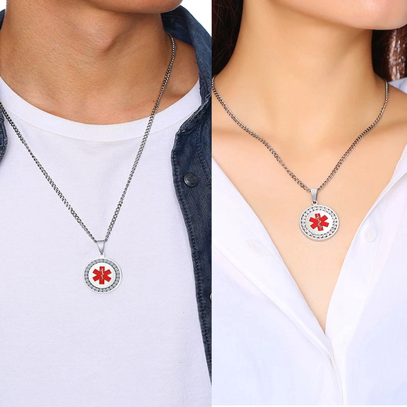 Silver unisex coin shaped medical alert pendant necklaces with cubic zirconia stones shown around a man and woman's neck.