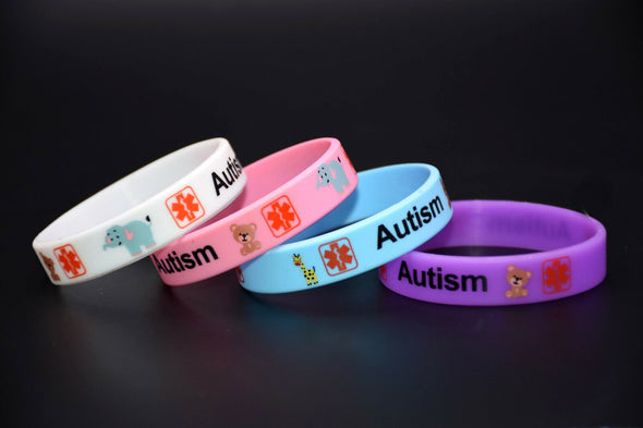 Kids Autism medical alert awareness silicone wristbands in white, pink, blue and pink.